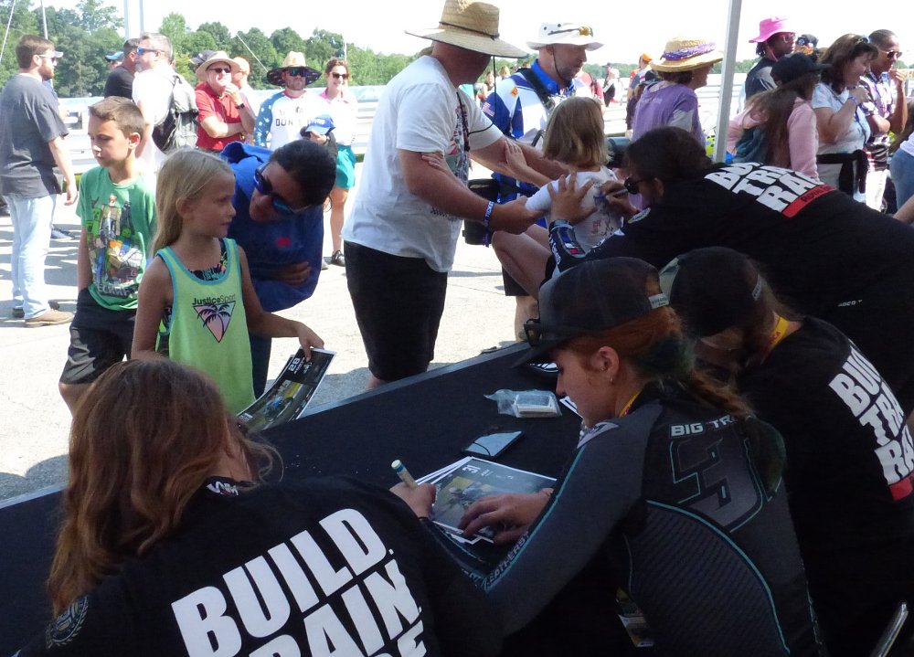 BTR racers sign autographs for two little girls, among other fans