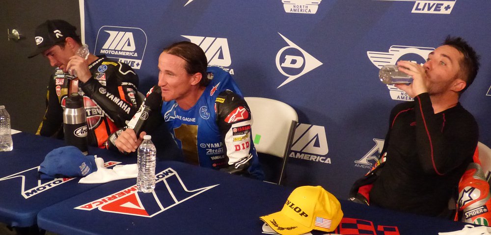three MotoAmerica Superbike riders sweating and drinking water after a race