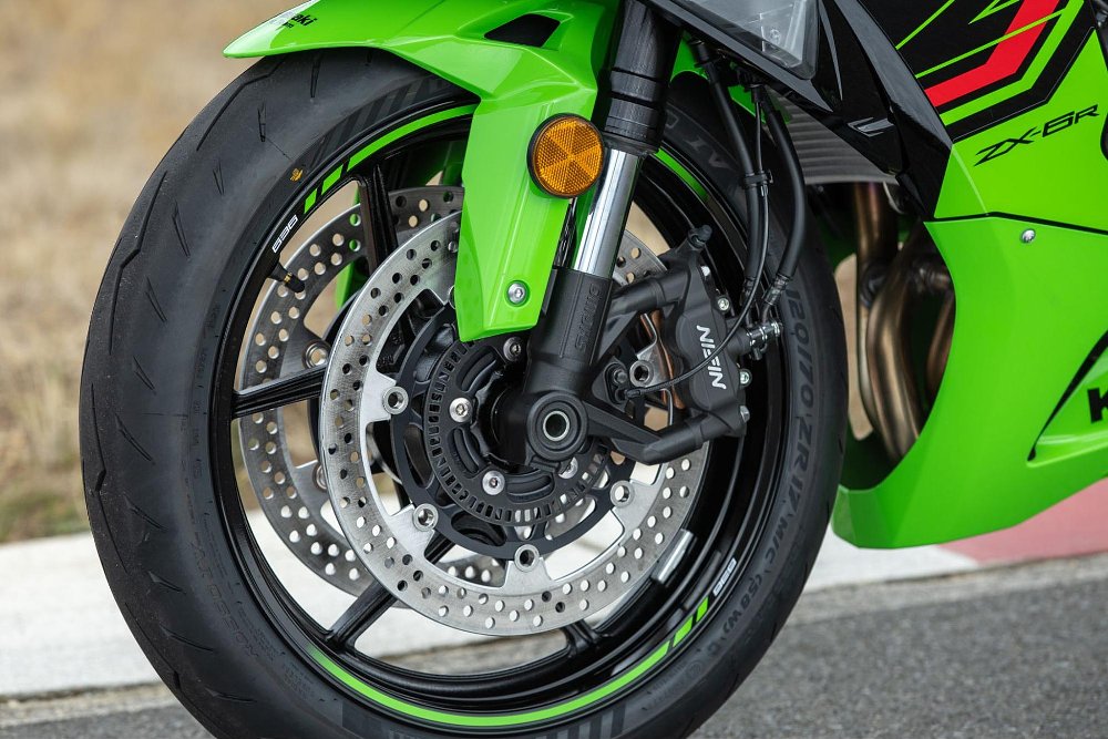 A close up view of front wheel, brakes, and fork of the 2024 Kawasaki Ninja zx-6r
