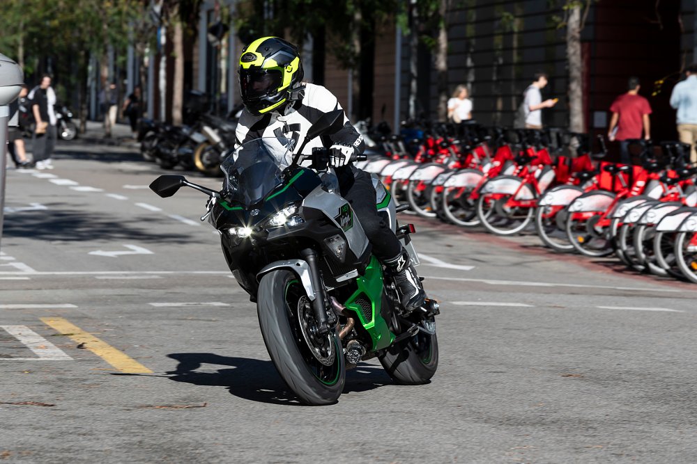 A female rider on board the ninja 7 hybrid in busy city streets of Barcelona spain