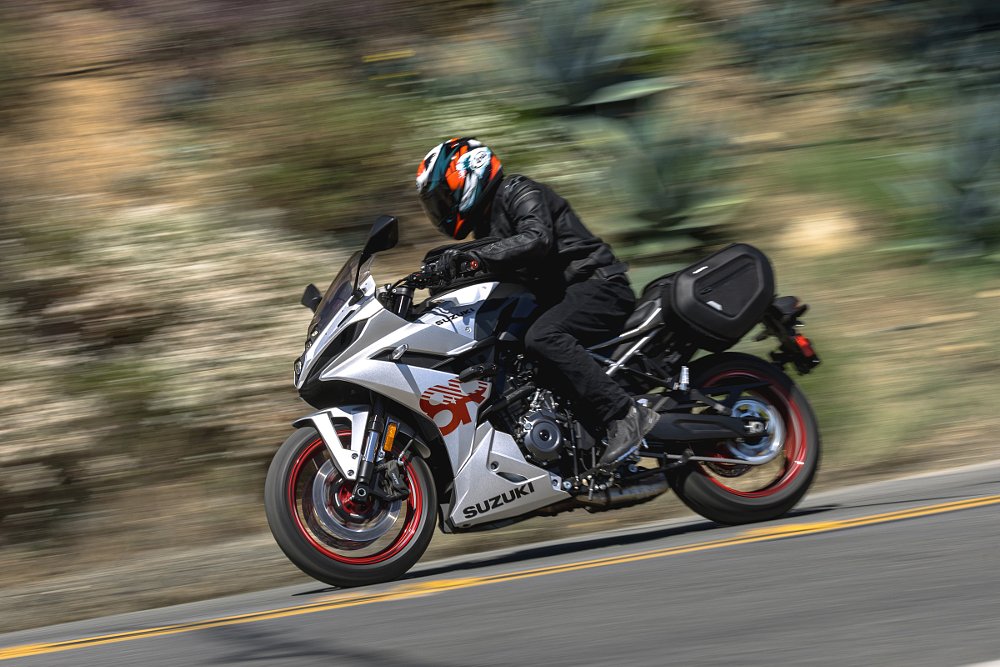silver GSX-8R on the road, equipped with panniers