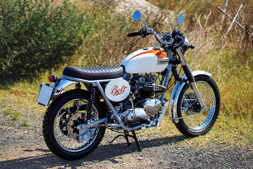 view of the orange and white motorcycle outside