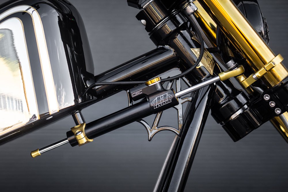 close up of steering damper and brace on the frame of the motorcycle