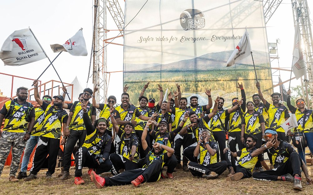 cheering group of riders in matching shirts