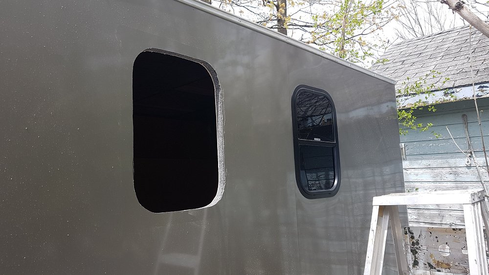 holes cut in the trailer walls for windows