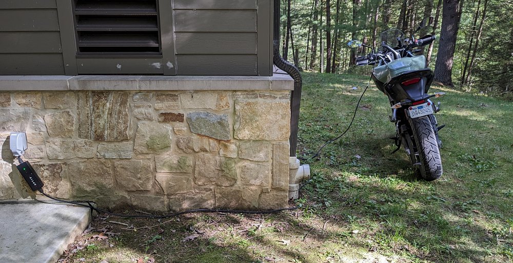 Zero DSR/X parked parked by the campground bathhouse and connected to the outlet