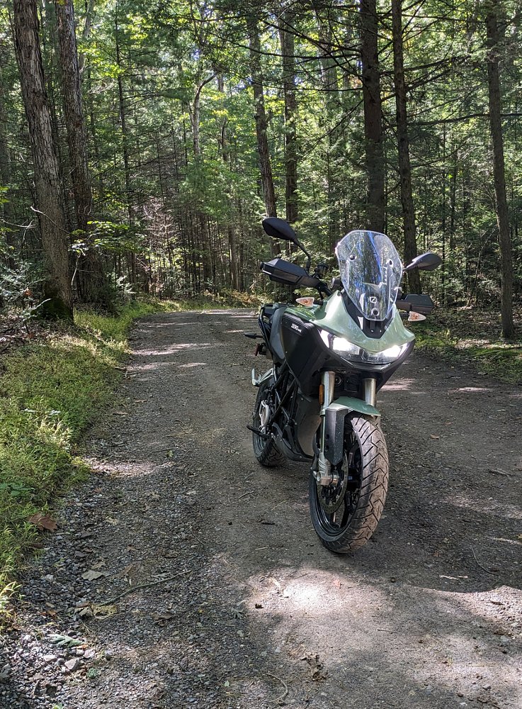The DSR/X parked on a smooth dirt road in the forest