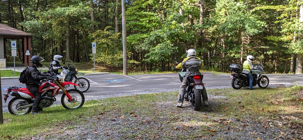 the four different motorcycles about to take off on the off-road ride