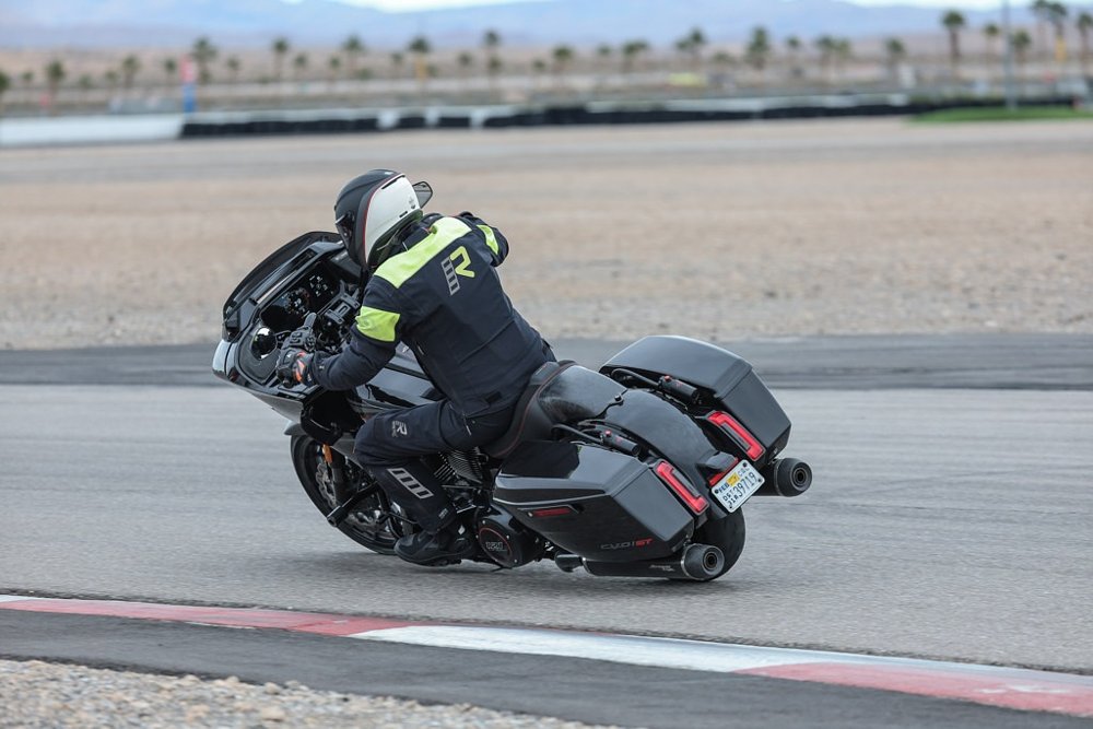 riding a black 2024 Harley-Davidson CVO Road Glide ST on the race track
