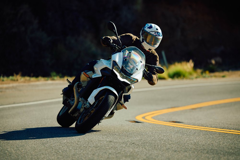 2023 Moto Guzzi V100 Mandello riding toward camera through a left hand turn