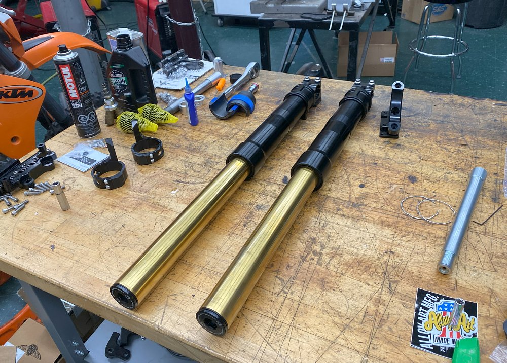 front suspension parts laid out on the work bench