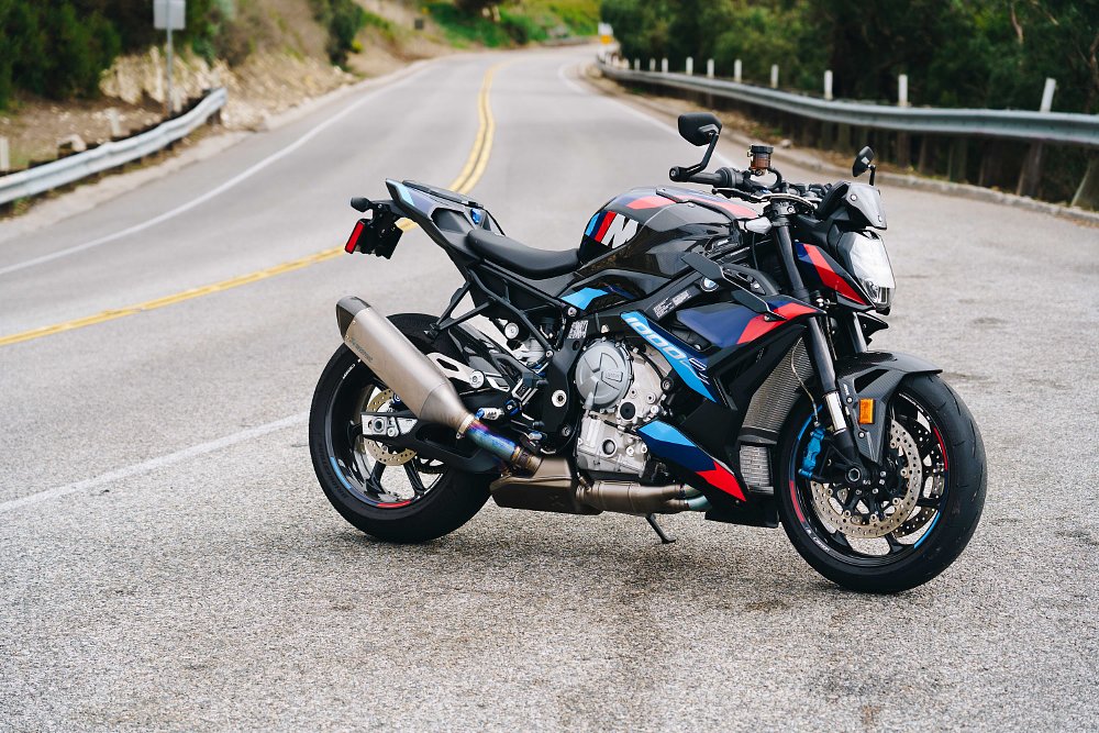 BMW M 1000 R parked on the side of a mountain road.