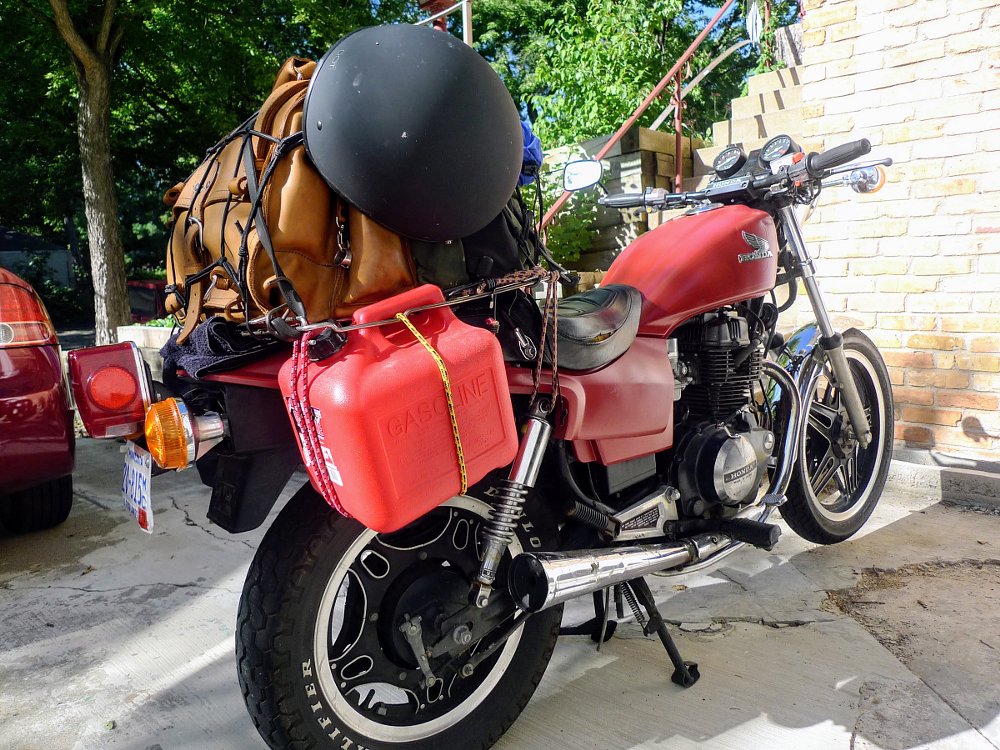 luggage attached to motorcycle with bungee cords