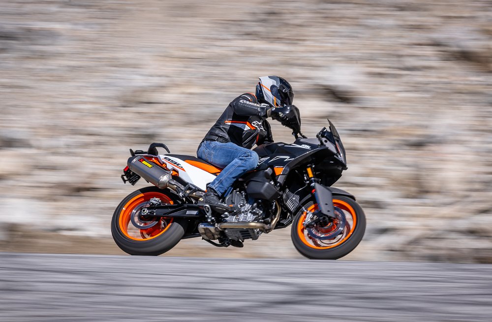 2024 KTM 890 SMT riding through a left-hand corner, from the right.