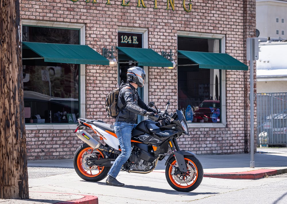 2024 KTM 890 SMT right side, waiting to pull out of an intersection in a town.