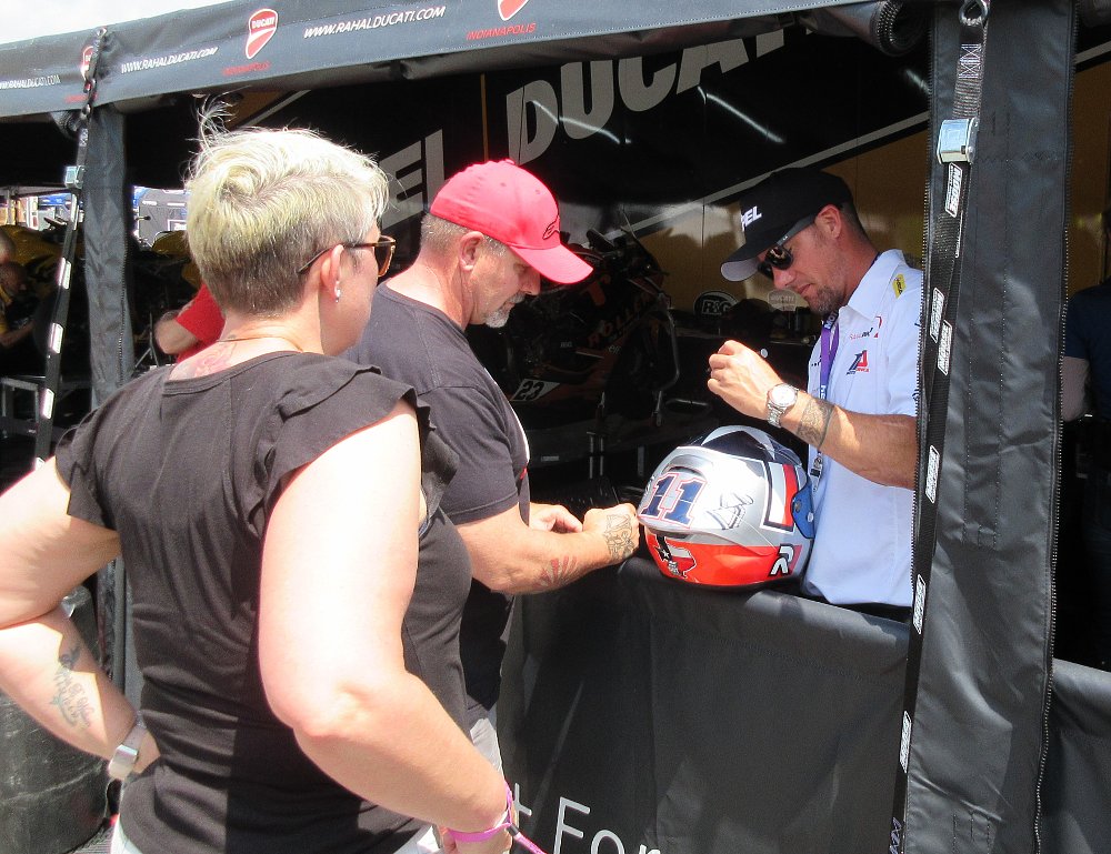 Ben Spies signs a helmet for a fan