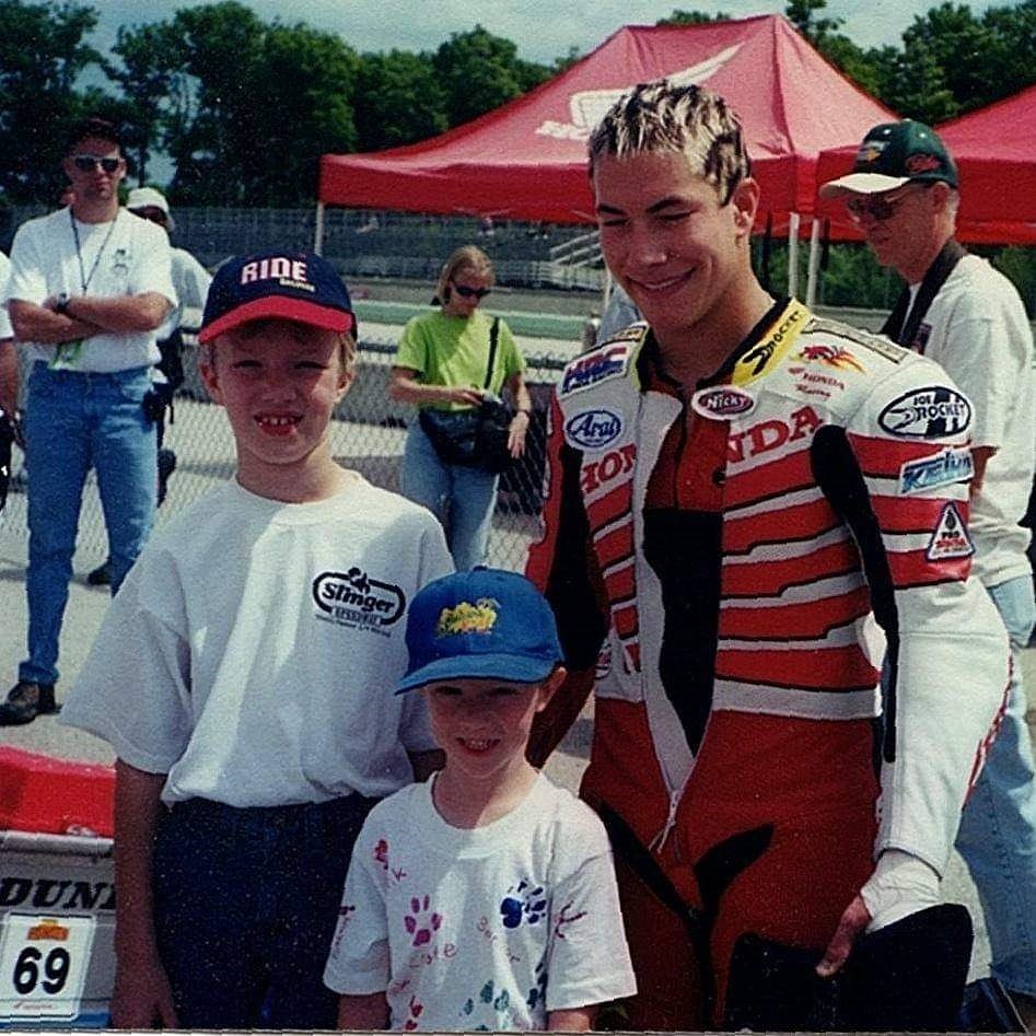 Andrew and Joel as boys posing with racer Nicky Hayden
