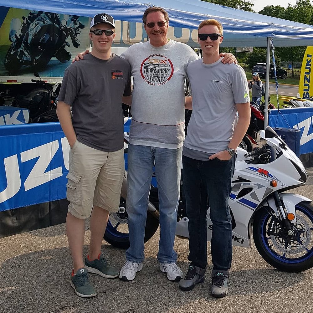 Andrew and Joel as adults with their father, Van, at the race track