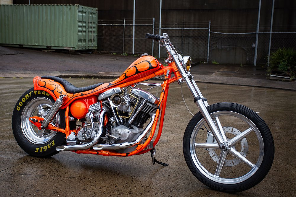 studio photo of side view of the orange custom chopper