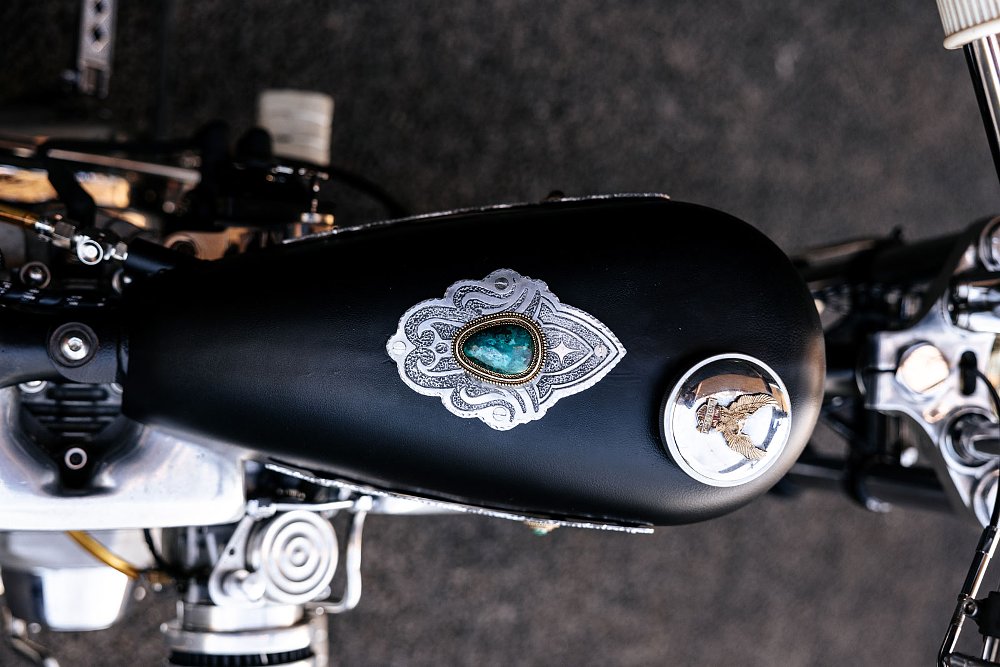 metal and turquoise adornment on the fuel tank