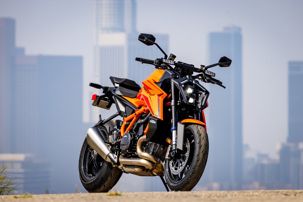 2024 KTM 1390 Super Duke R parked with downtown Los Angeles in the background.