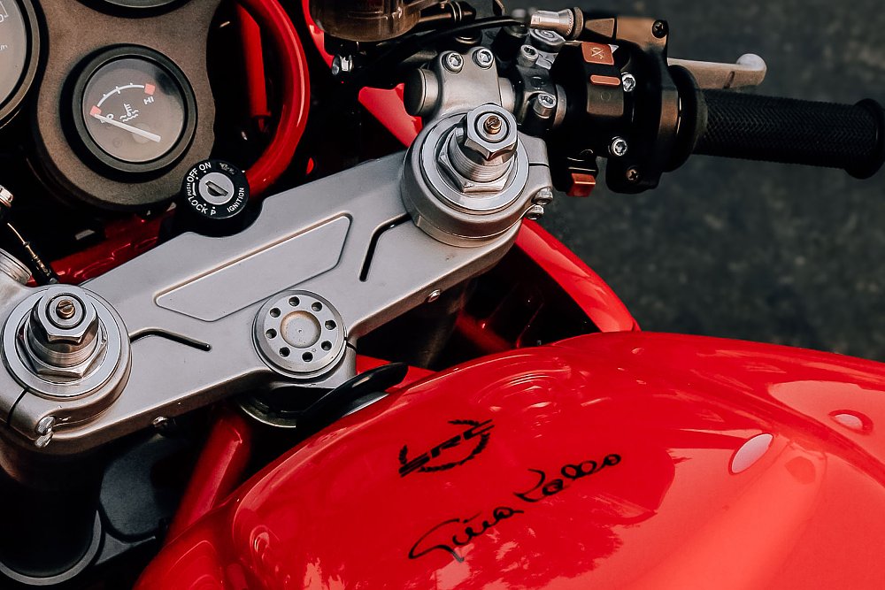 close up view of the top triple clamp and part of the red fuel tank