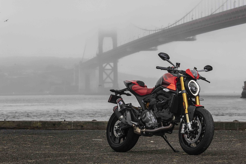 A 2024 Ducati Monster SP sits parked with the Golden Gate Bridge behind.