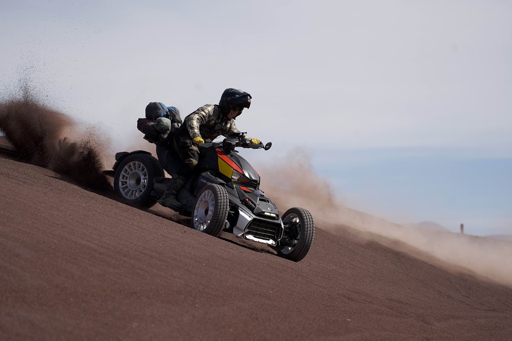 A Can-Am Ryker Rally roosting sand as it slides across a dune.