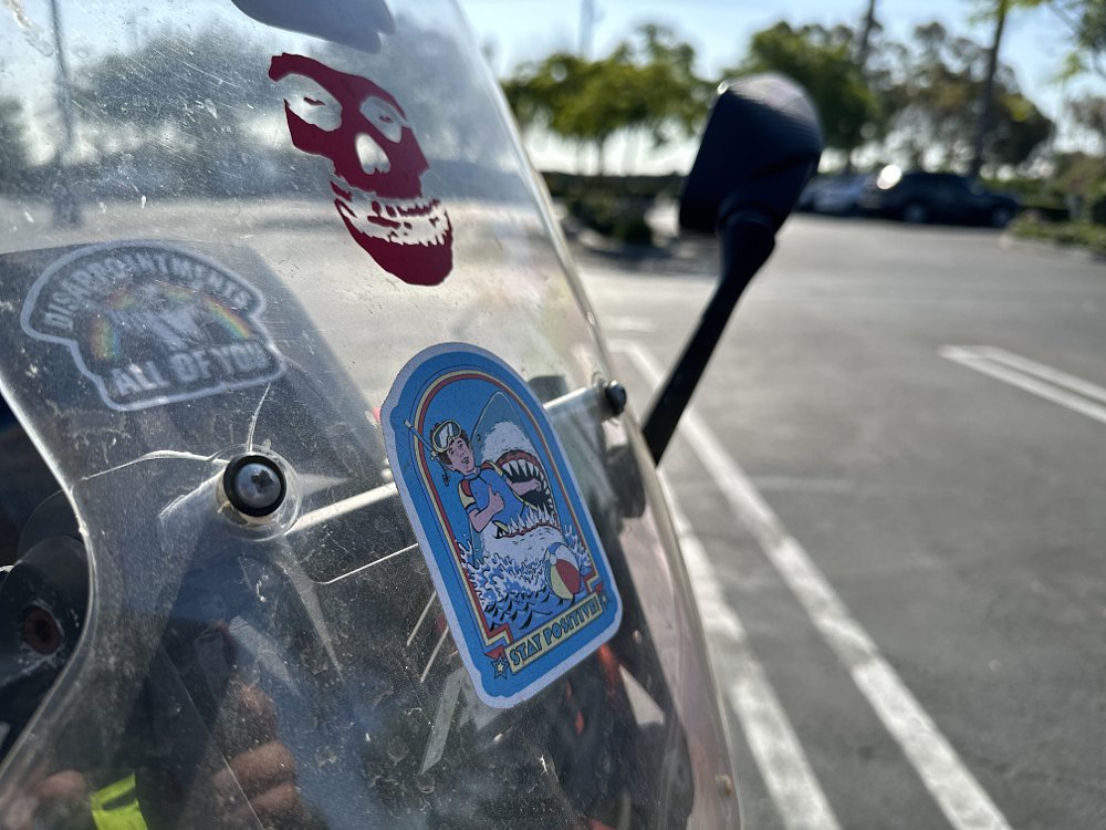 Detail image of a sticker on the fairing of a Honda ADV150 scooter.
