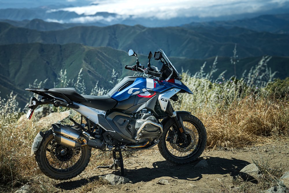 2024 BMW R 1300 GS Trophy parked at a high point with hilltops in the background.