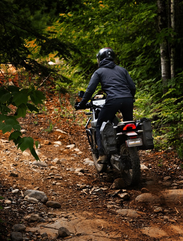 The Can-Am Origin riding on a trail in the woods
