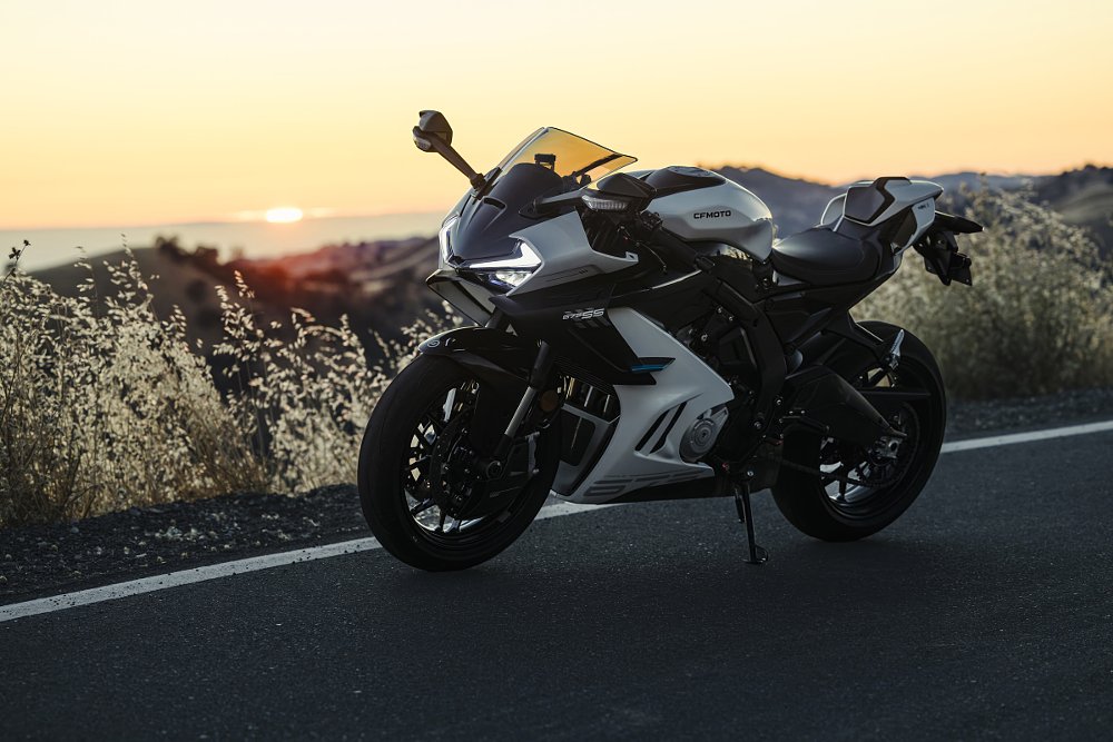 white 675SS parked in front of a sunset