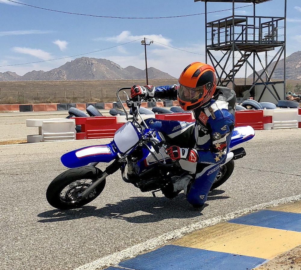 rider on a small TTR-125 motorcycle in a corner