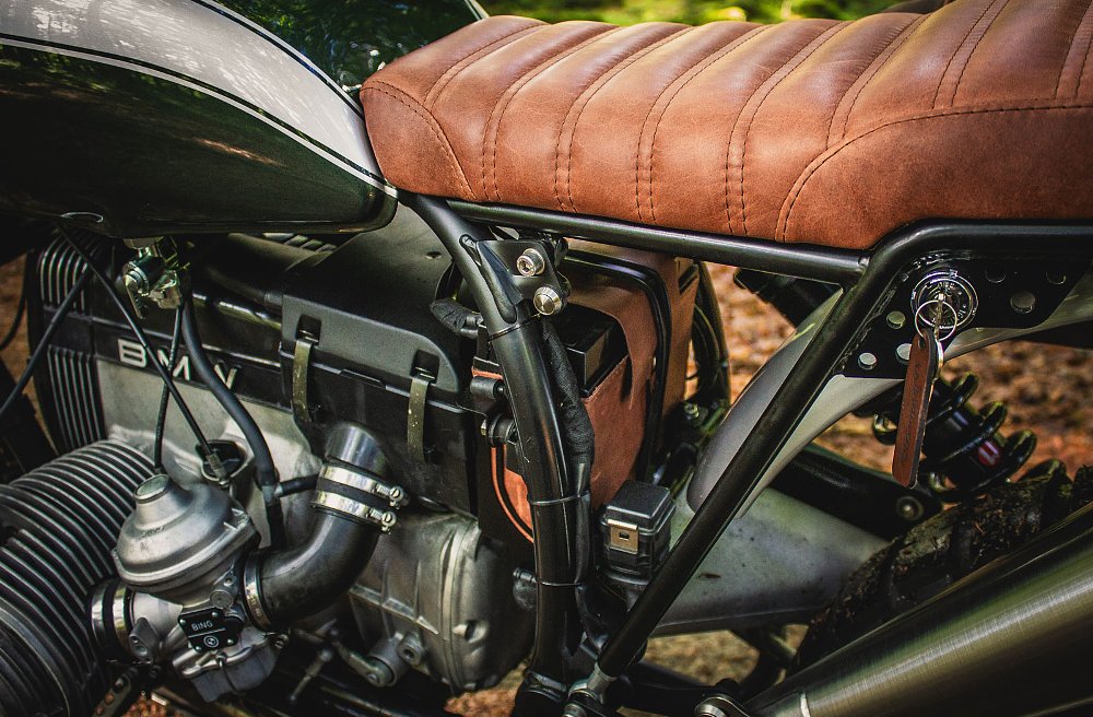 close shot of engine with battery in a leather case