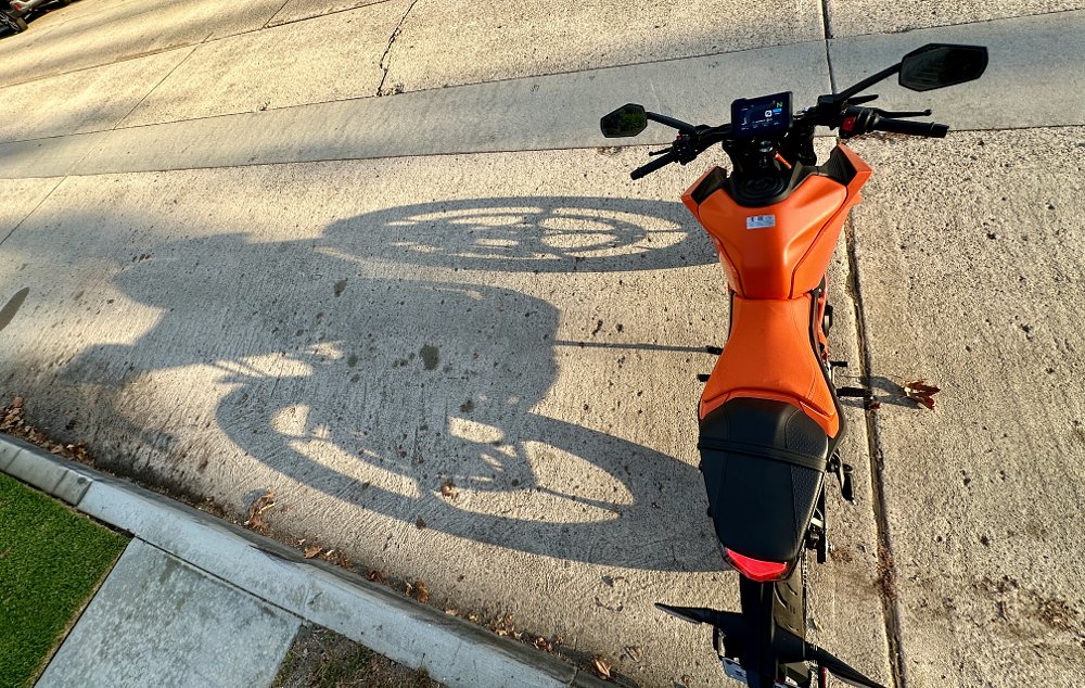 2024 KTM 390 Duke shot from above, with a shadow cast to its right.