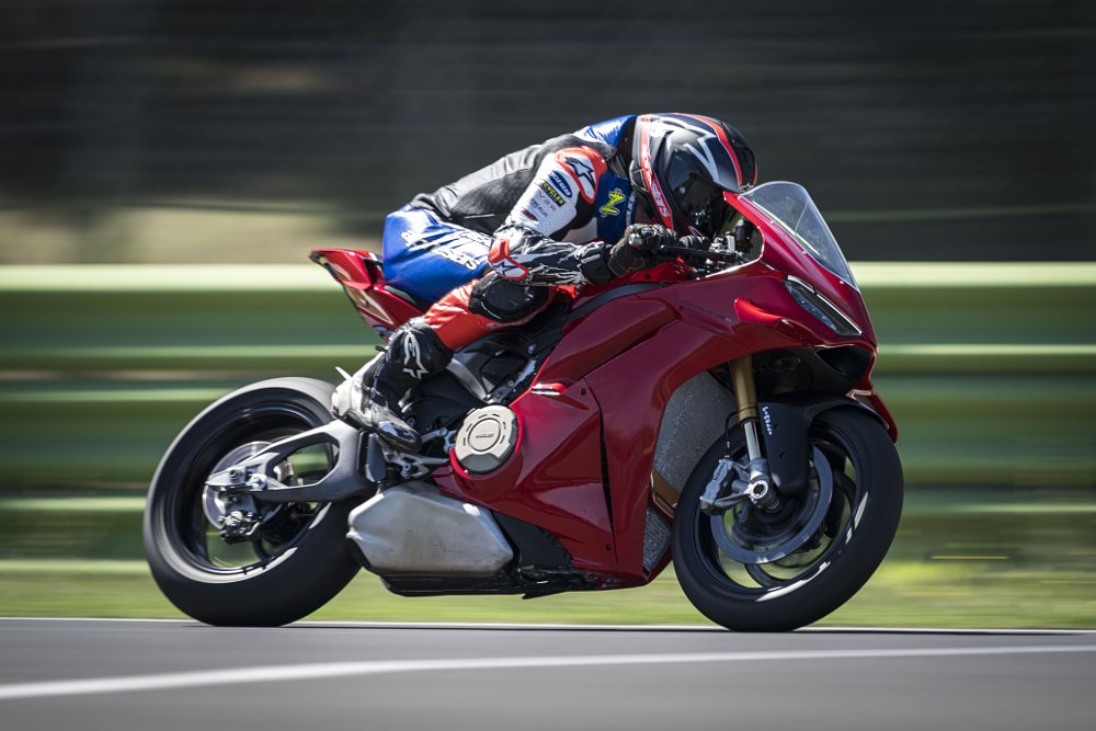 2025 Ducati Panigale V4 S speeding down a straightaway on a race track.