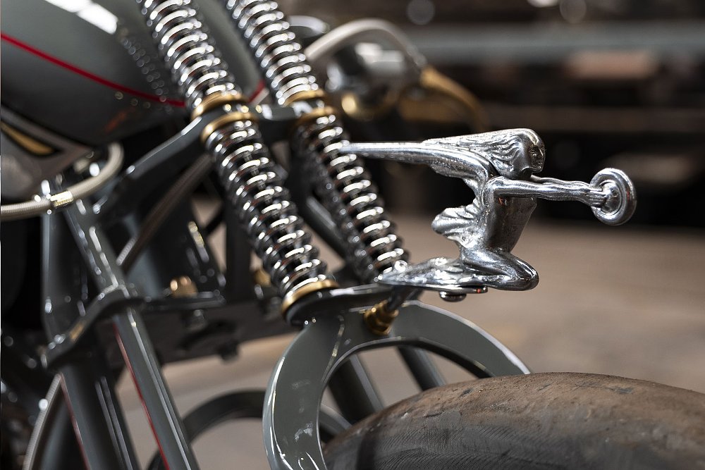 silver colored statue on the front of the motorcycle
