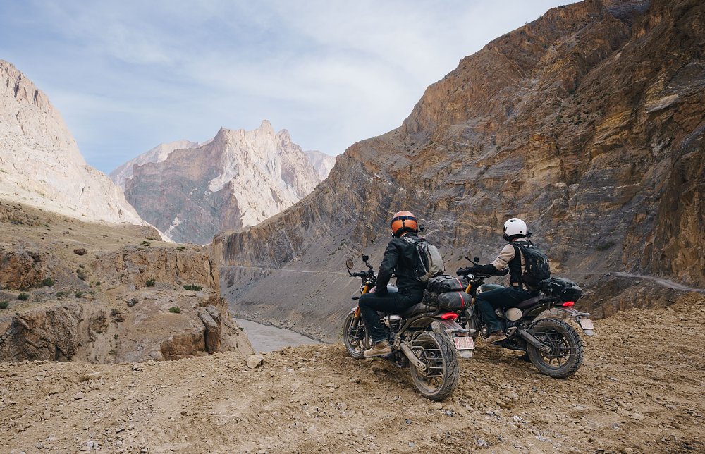 Zack and Spurgeon on motorcycles overlooking a mountain gorge in the Himalayans