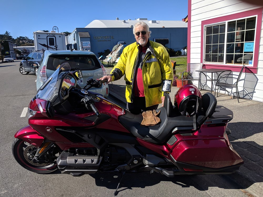 the author wearing a hi-viz jacket behind a dark red Gold Wing
