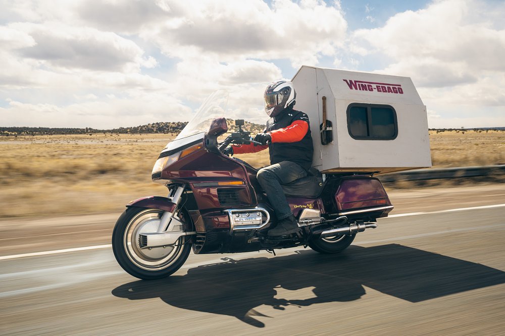 Ari riding the Gold Wing with a wood sleeping compartment built on the back seat