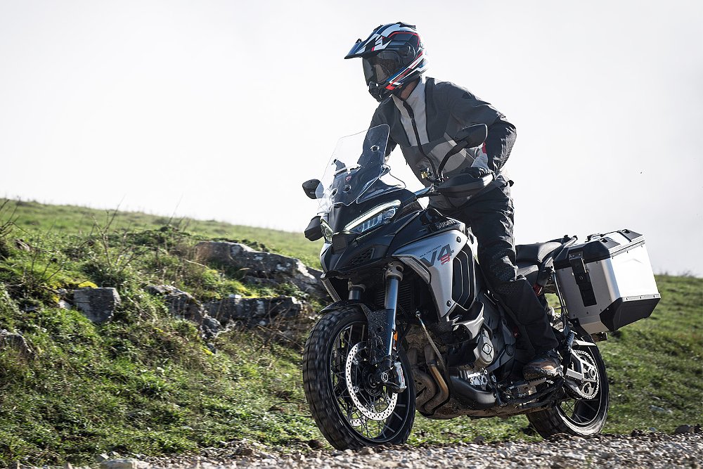 Dustin trundles over a gravel path while aboard the Multistrada V4 S.