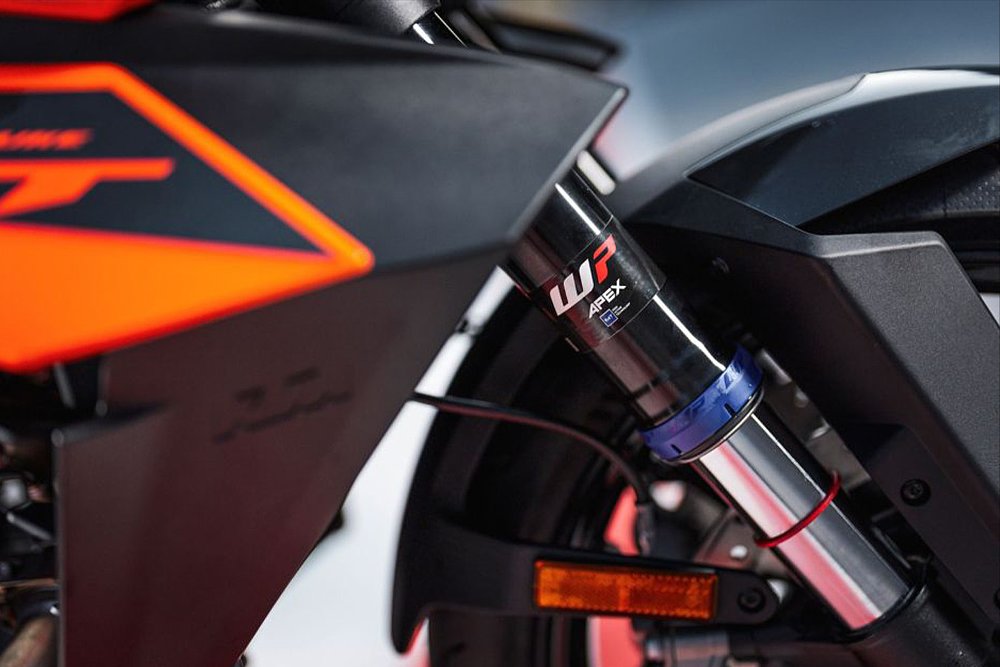 A close-up of the 2025 KTM 1390 Super Duke GT's WP APEX semi-active suspension.