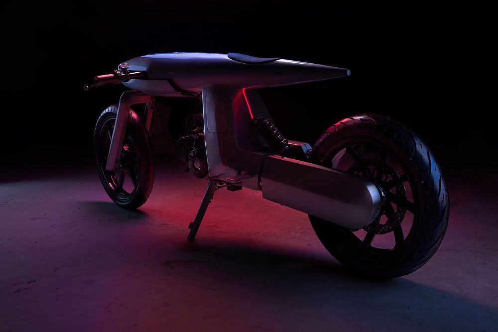 dark studio photo of the missile-shaped motorcycle from the rear