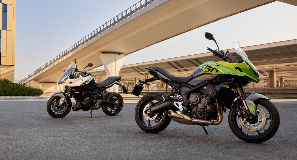 white and green versions of the Tiger Sport 660 parked under a bridge