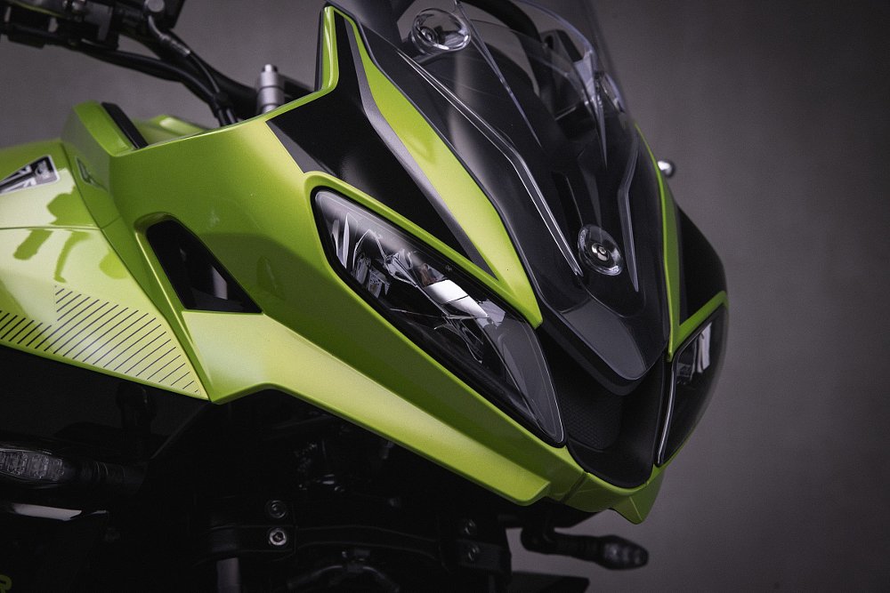 close up studio photo of the front fairing and headlights on the gree Tiger Sport 660