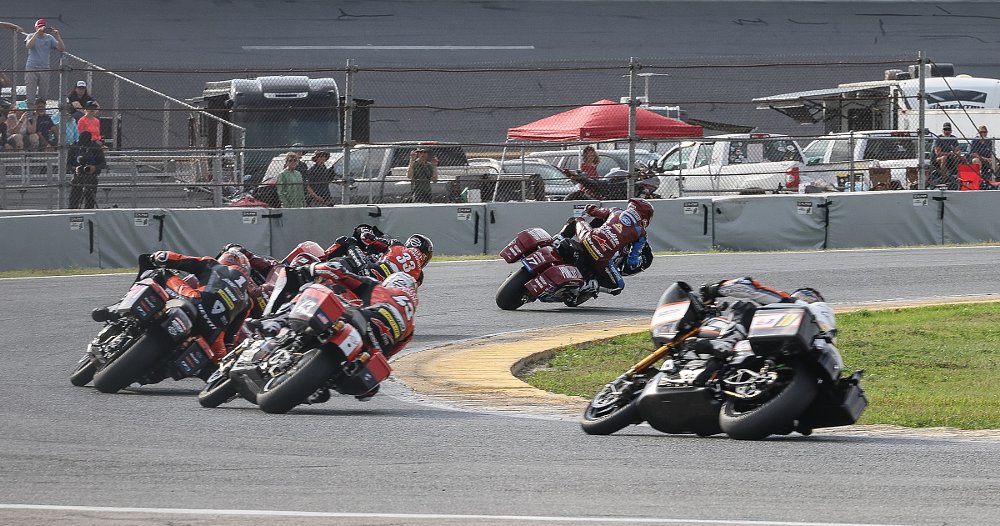 King of the Baggers race bikes leaning through a curve at Daytona