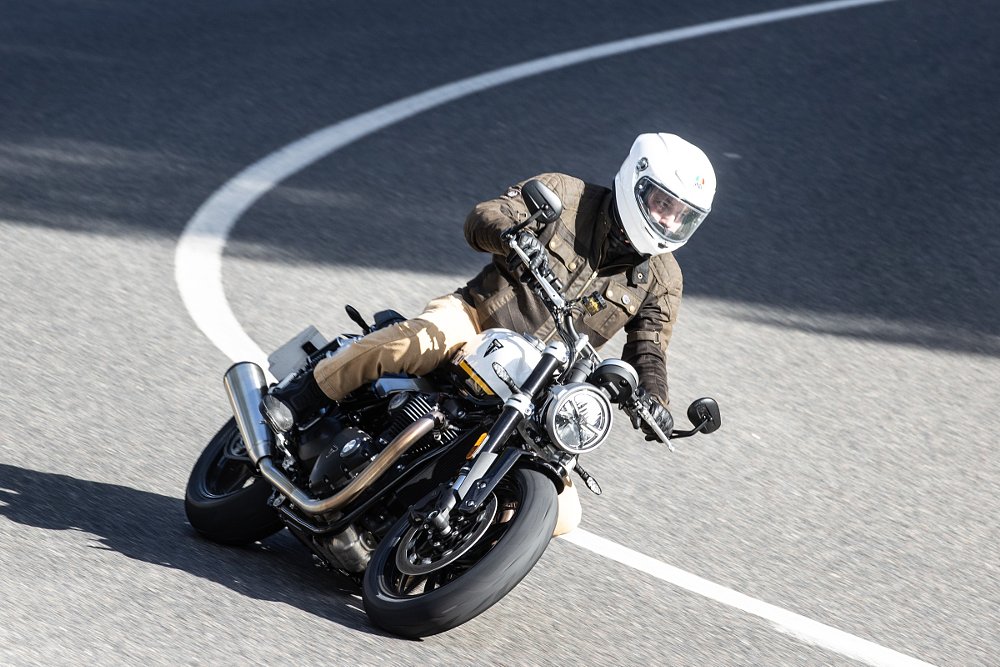 rider on a white Speed Twin 1200 leaned over in a corner