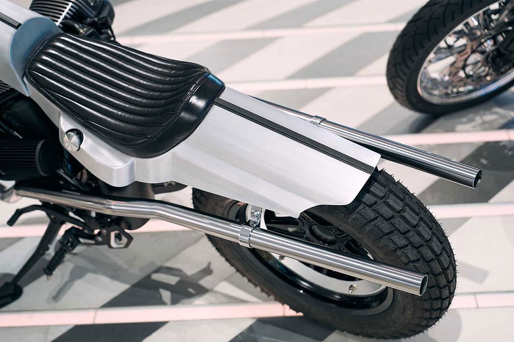 view of slender, silver rear body work and straight pipes on the R 12 custom