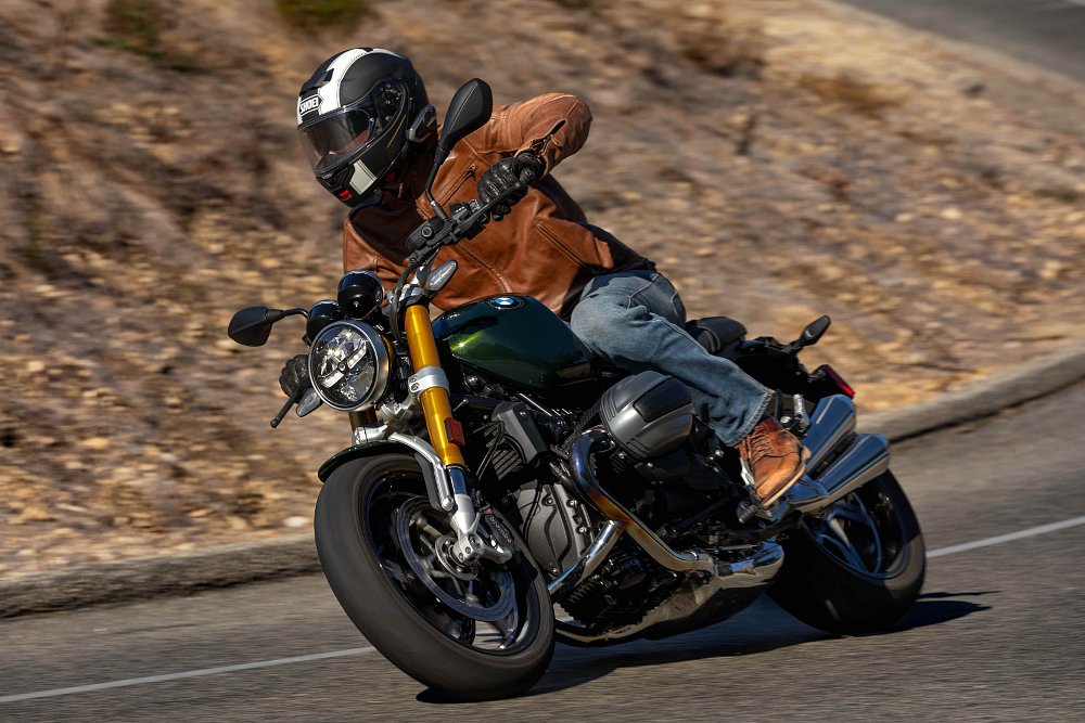 2024 BMW R 12 nineT riding through a right-hand corner, leaning away from camera..