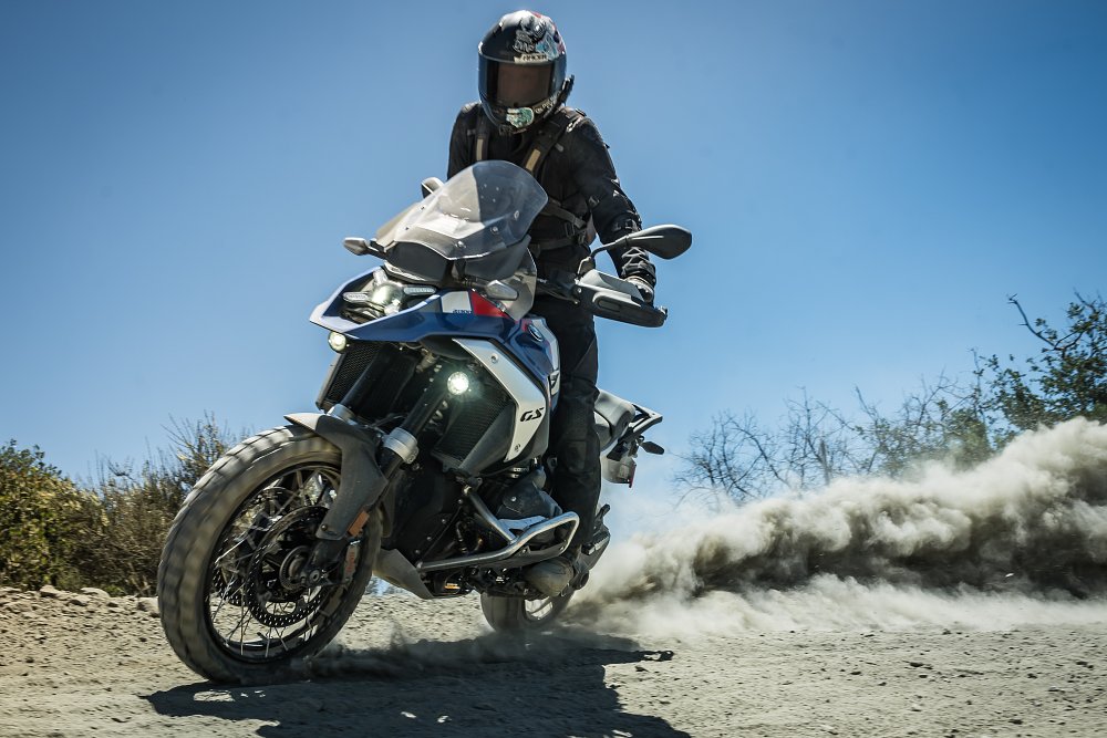 2024 BMW R 1300 GS sliding on a dirt road.
